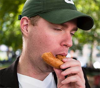 man eating a donut
